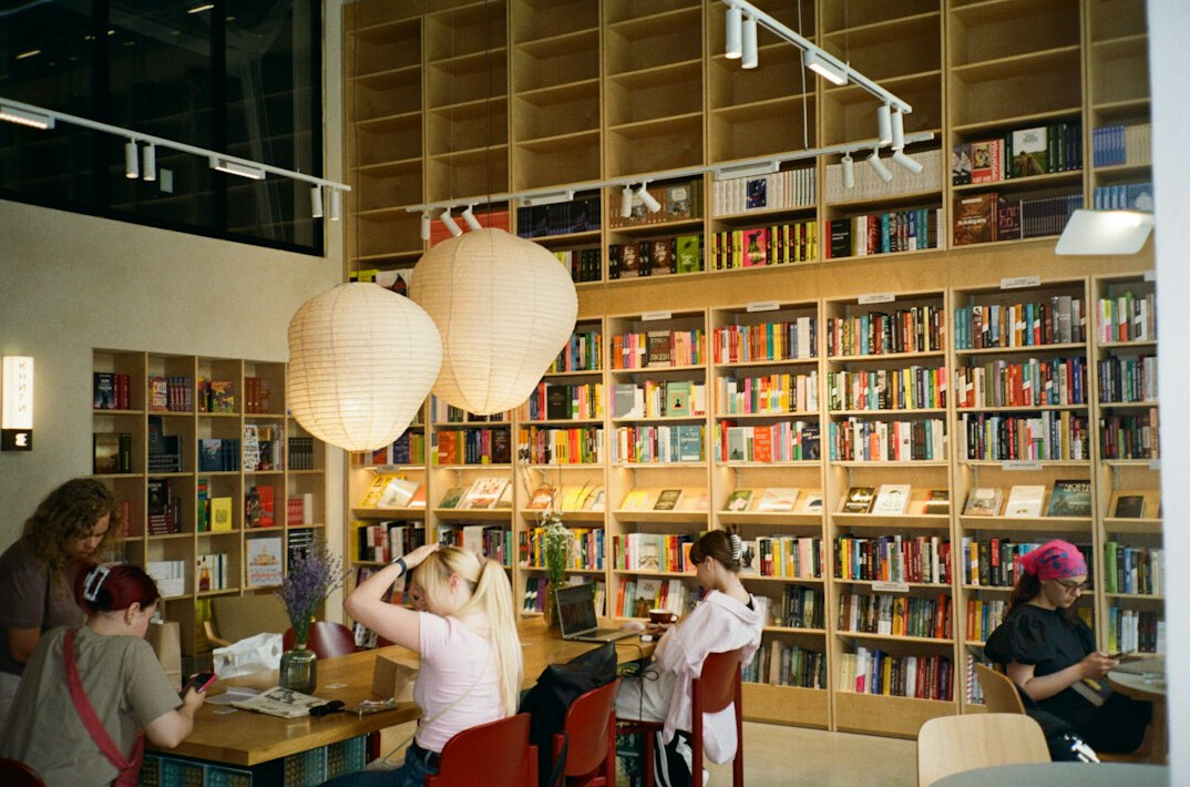 person reading book in cafe